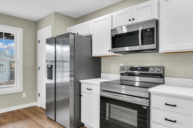 kitchen featuring white cabinetry, light hardwood / wood-style floors, and appliances with stainless steel finishes