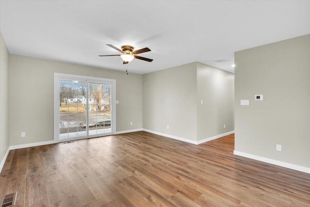 unfurnished room with ceiling fan and light wood-type flooring