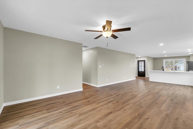 unfurnished living room with light hardwood / wood-style floors and ceiling fan