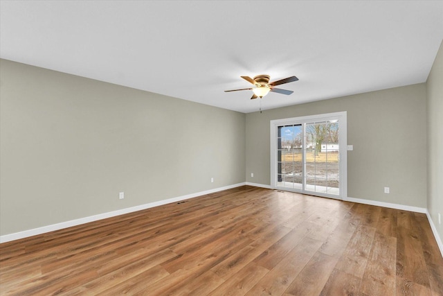 empty room featuring light hardwood / wood-style flooring and ceiling fan