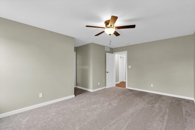 carpeted spare room featuring ceiling fan