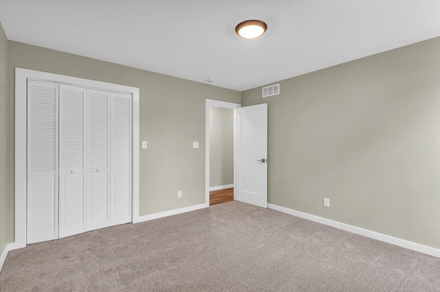 unfurnished bedroom with a closet and carpet