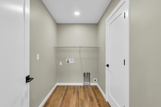 washroom with hardwood / wood-style flooring, electric dryer hookup, and washer hookup