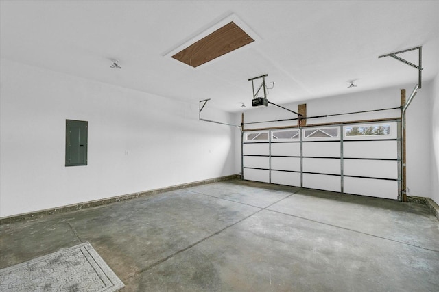 garage with a garage door opener and electric panel