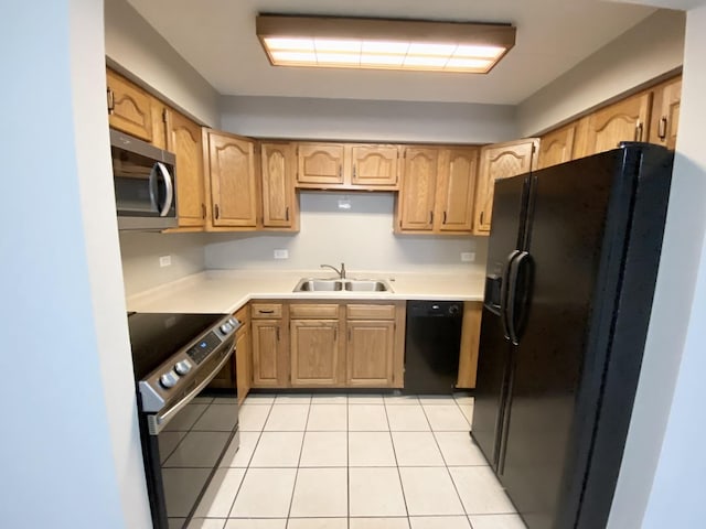 kitchen with black appliances, light tile patterned flooring, and sink