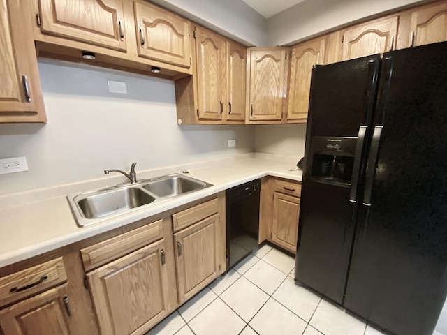 kitchen with light tile patterned floors, sink, and black appliances