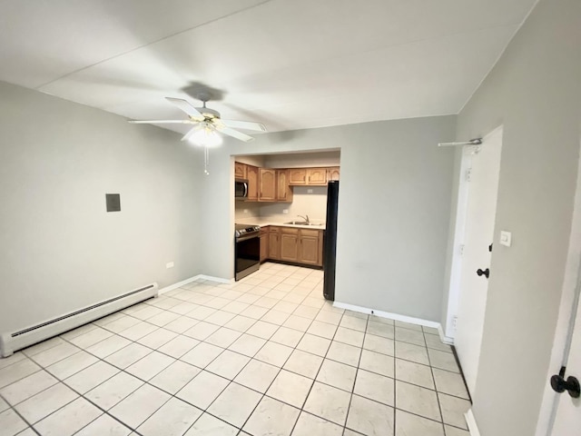 kitchen with ceiling fan, sink, baseboard heating, light tile patterned floors, and appliances with stainless steel finishes