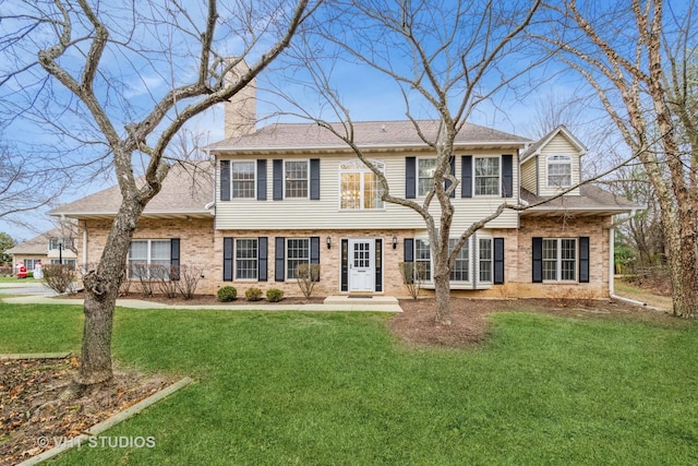 colonial inspired home with a front lawn