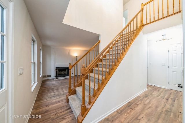 staircase with hardwood / wood-style flooring and plenty of natural light