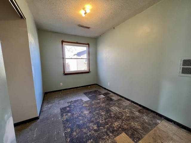 empty room featuring a textured ceiling