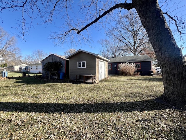 rear view of house featuring a yard