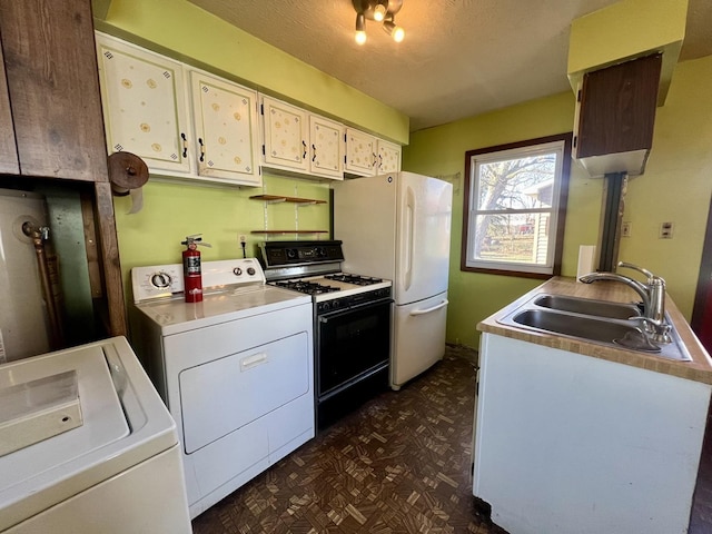 kitchen with a textured ceiling, sink, white appliances, and independent washer and dryer