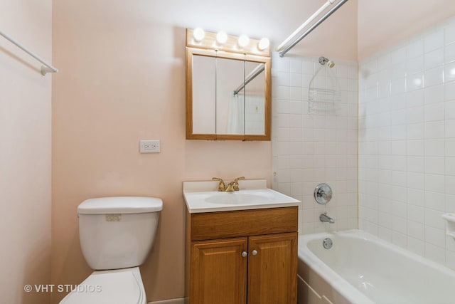 bathroom featuring toilet, vanity, and washtub / shower combination