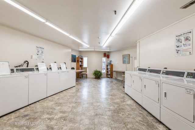 common laundry area featuring washing machine and dryer and visible vents