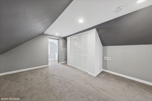 bonus room featuring carpet flooring and lofted ceiling