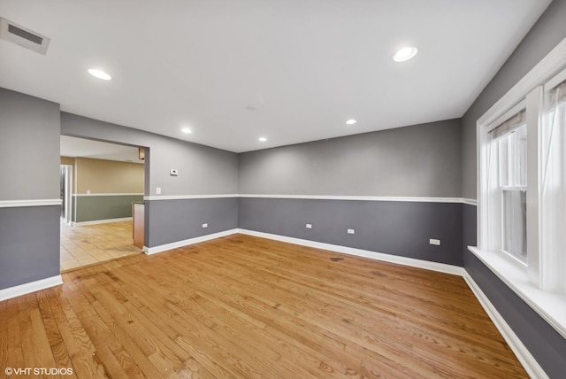 empty room with light hardwood / wood-style flooring