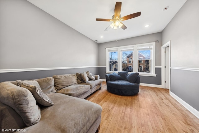 living room featuring ceiling fan and light hardwood / wood-style flooring