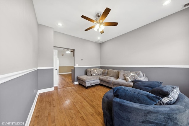 living room with ceiling fan and wood-type flooring