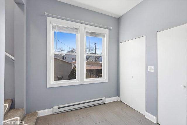 empty room featuring light hardwood / wood-style floors and baseboard heating