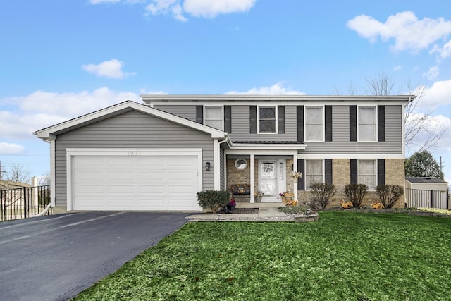 front facade featuring a garage and a front lawn