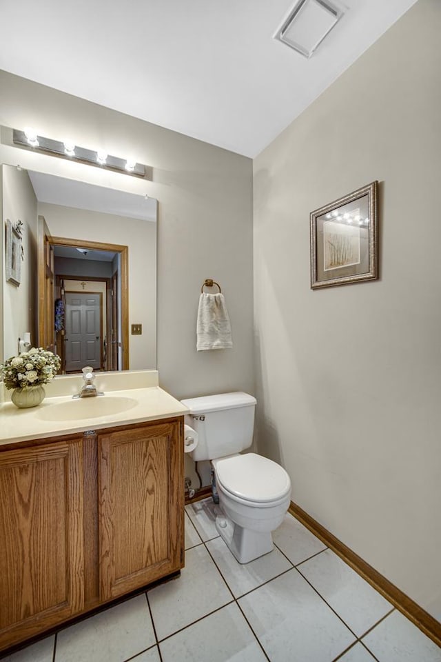 bathroom featuring vanity, toilet, and tile patterned floors