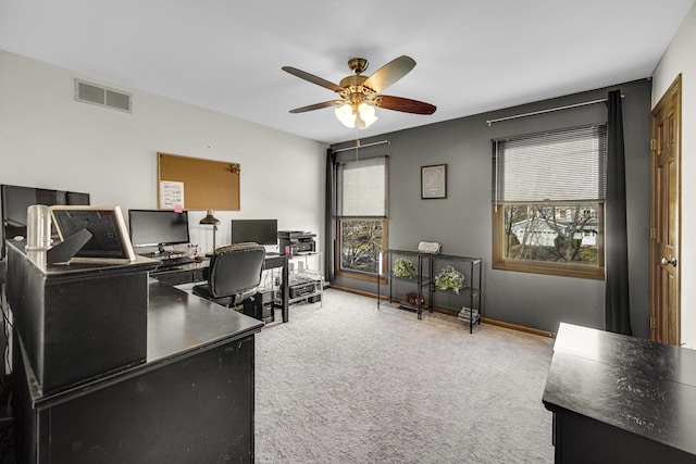 carpeted home office with plenty of natural light and ceiling fan