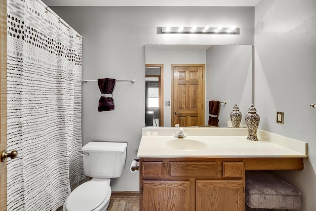 bathroom featuring a shower with shower curtain, vanity, hardwood / wood-style flooring, and toilet