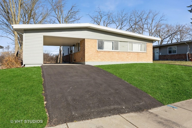 view of front facade with a front yard and a carport