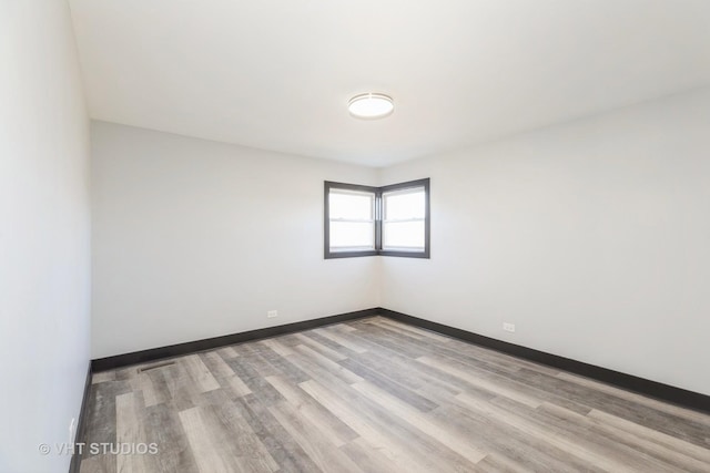 spare room featuring light hardwood / wood-style flooring