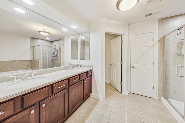 bathroom with tile patterned flooring, vanity, and a shower with shower door