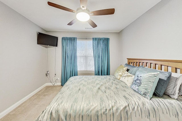 bedroom with ceiling fan and light carpet