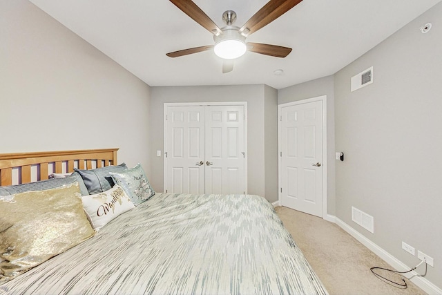 bedroom with light colored carpet, a closet, and ceiling fan