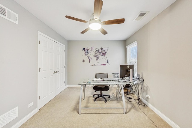 home office featuring light carpet and ceiling fan