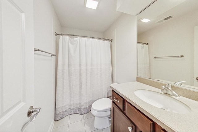 bathroom featuring toilet, vanity, and tile patterned floors