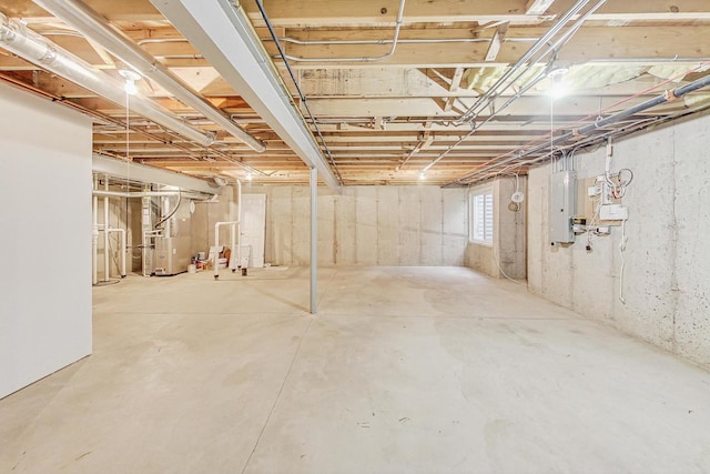 basement with electric panel and heating unit