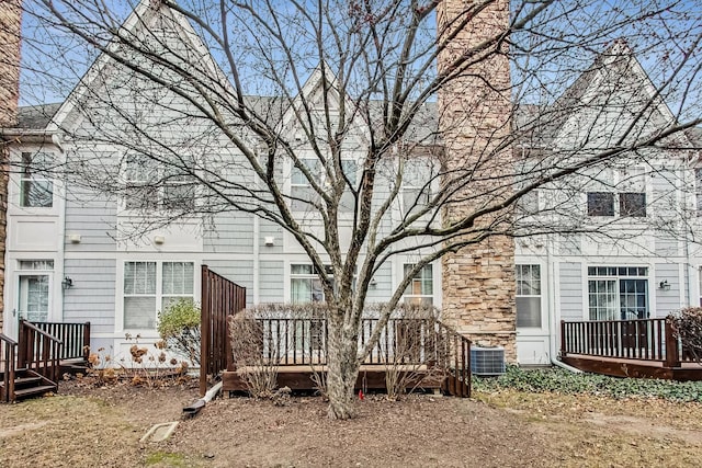 view of yard with a deck and central AC