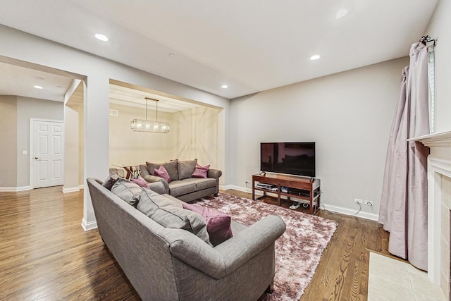 living room featuring a chandelier and hardwood / wood-style flooring