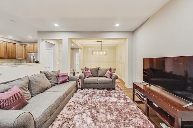 living room featuring a chandelier and hardwood / wood-style floors