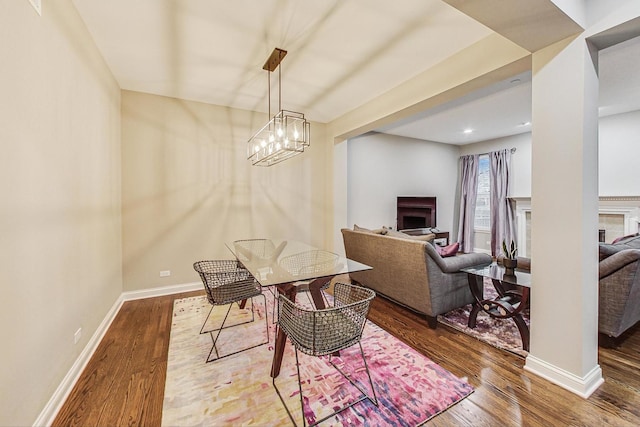 dining area featuring hardwood / wood-style floors and a chandelier