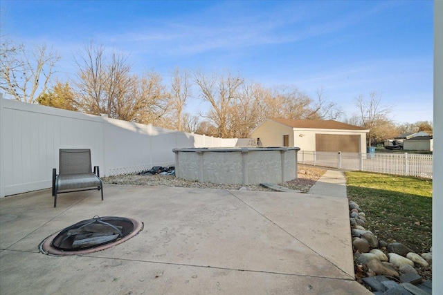 view of patio / terrace with a fenced in pool and an outdoor fire pit