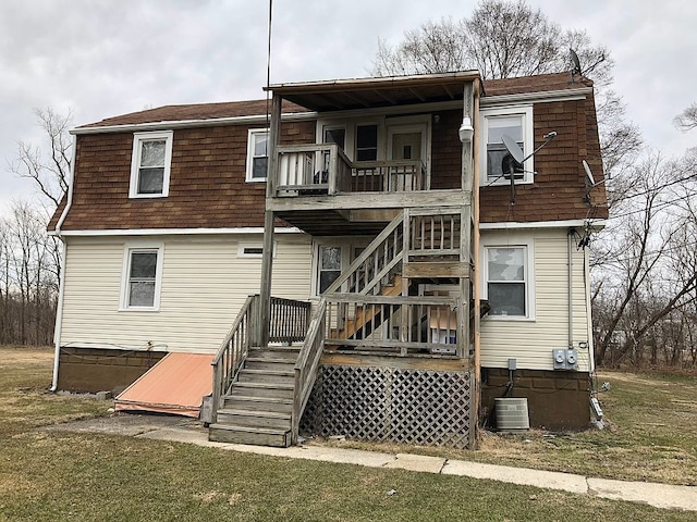 back of house featuring a yard and central AC unit