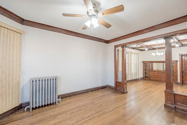 spare room featuring radiator, ornamental molding, ornate columns, and light hardwood / wood-style floors