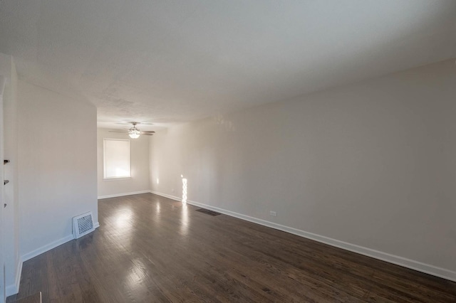 spare room featuring dark hardwood / wood-style floors and ceiling fan