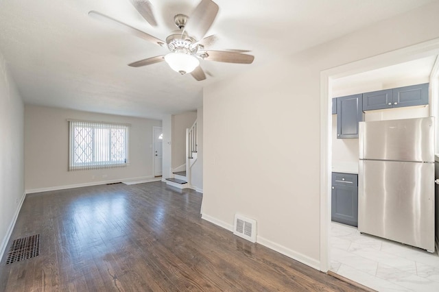 unfurnished living room featuring ceiling fan and light wood-type flooring