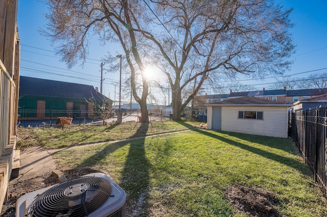 view of yard featuring central AC and an outdoor structure