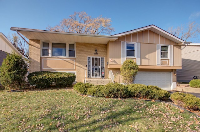 split foyer home featuring a garage and a front lawn