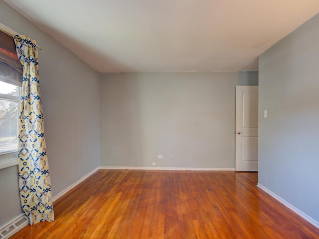 unfurnished room with hardwood / wood-style flooring