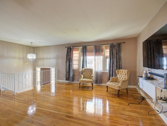 living area featuring light hardwood / wood-style flooring and a notable chandelier