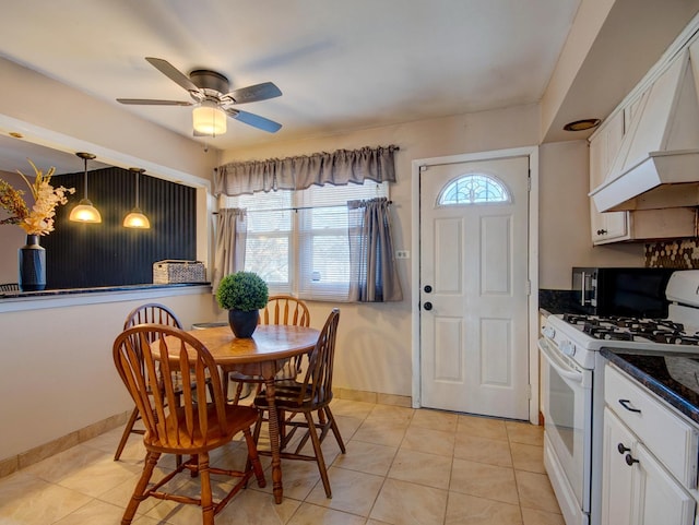 dining room with ceiling fan and light tile patterned floors