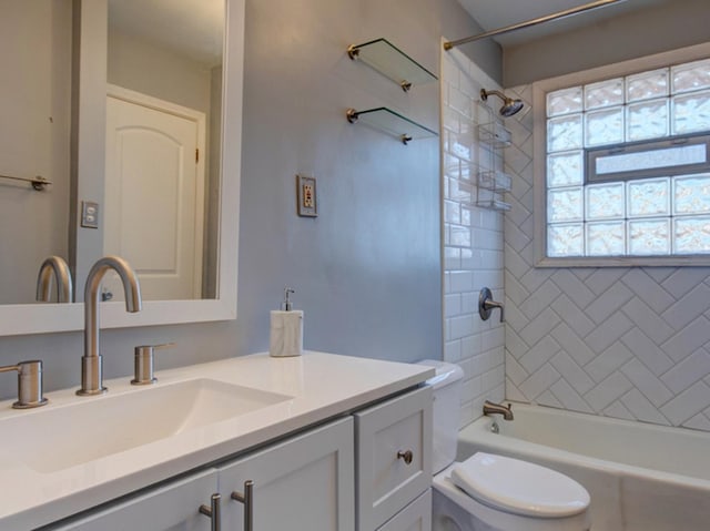 full bathroom with vanity, toilet, and tiled shower / bath